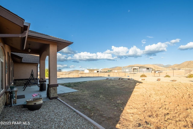 view of yard with a mountain view and a patio area