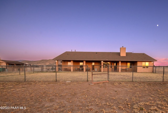 back house at dusk with a mountain view