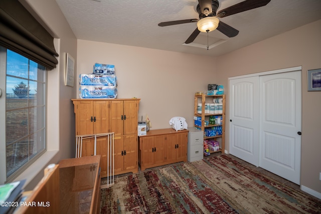 unfurnished bedroom featuring ceiling fan, a closet, and a textured ceiling