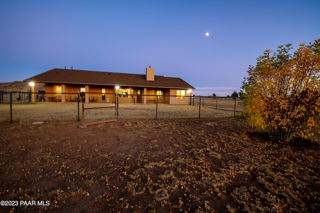 view of back house at dusk