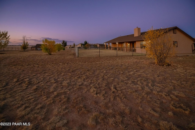 view of yard at dusk