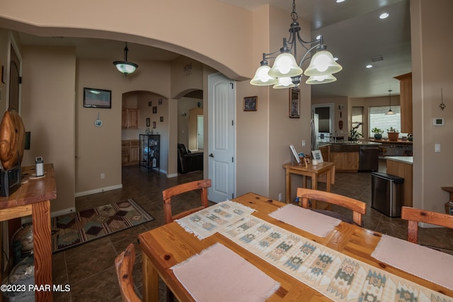 tiled dining room featuring a notable chandelier