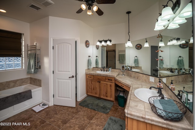 bathroom with tile patterned floors, ceiling fan, shower with separate bathtub, and vanity