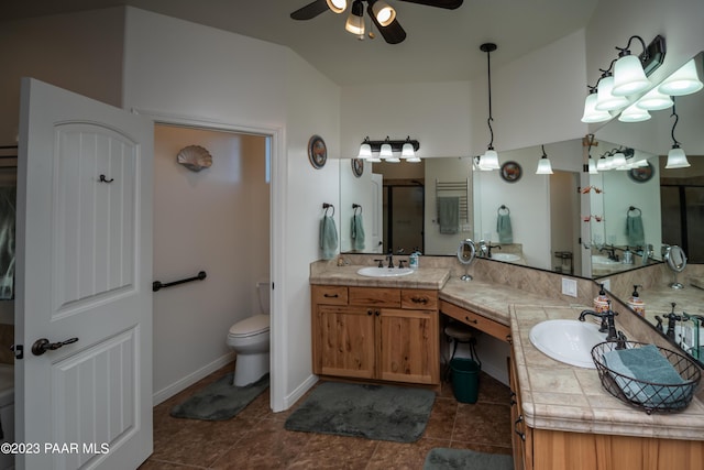 bathroom featuring ceiling fan, lofted ceiling, toilet, a shower with door, and vanity