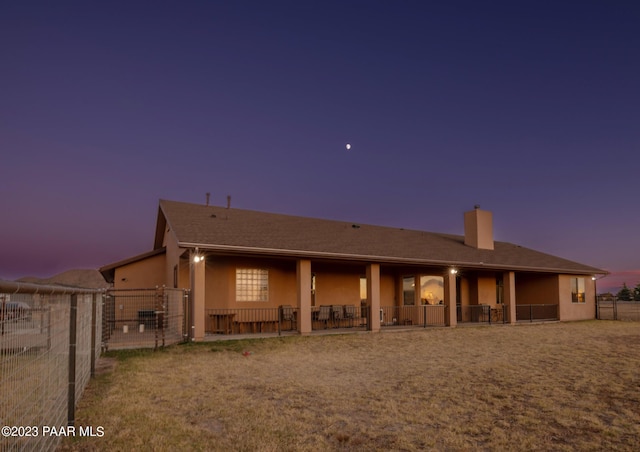 view of back house at dusk