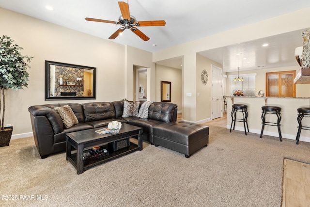 living room with light colored carpet and ceiling fan