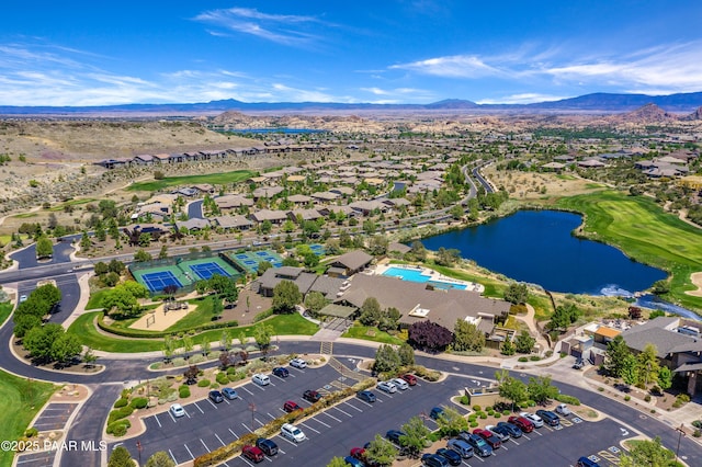 drone / aerial view featuring a water and mountain view