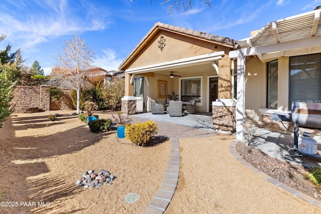 rear view of house with a patio and ceiling fan