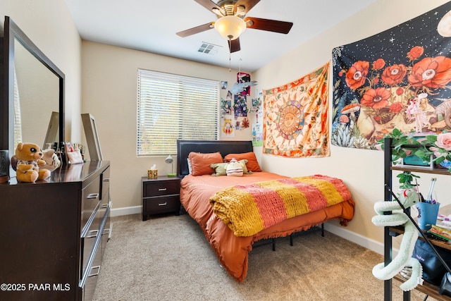 bedroom with ceiling fan and light carpet