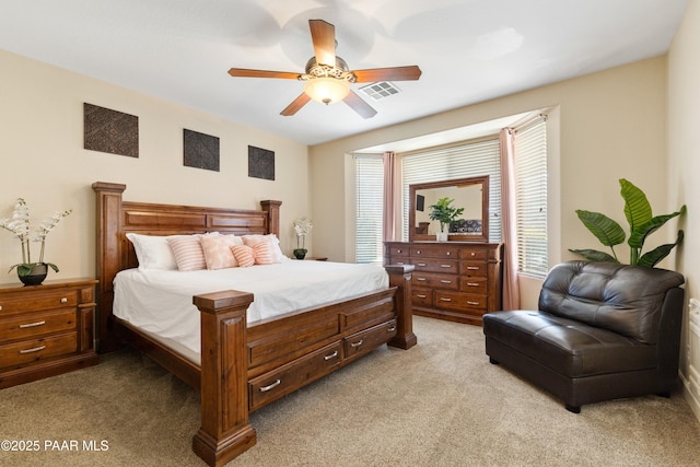 bedroom featuring light colored carpet and ceiling fan