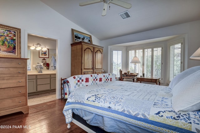 bedroom featuring connected bathroom, dark hardwood / wood-style floors, vaulted ceiling, and ceiling fan