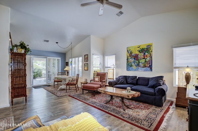 living room with a wealth of natural light, ceiling fan, high vaulted ceiling, and hardwood / wood-style flooring