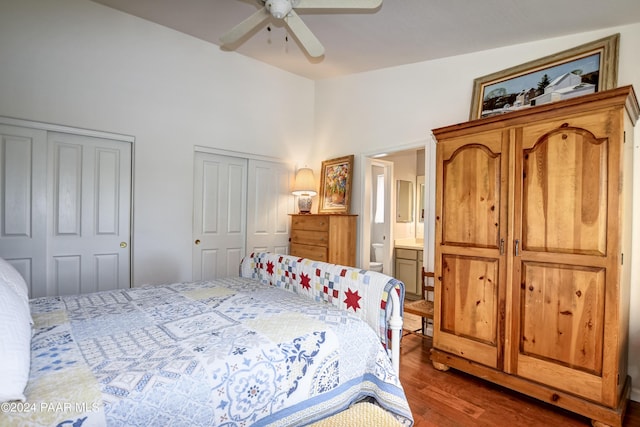 bedroom with multiple closets, ceiling fan, hardwood / wood-style floors, and ensuite bath