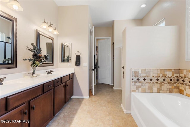 921 N Soliz St, Dewey-Humboldt, AZ 86327 - bathroom featuring a garden tub, double vanity, baseboards, and tile patterned flooring