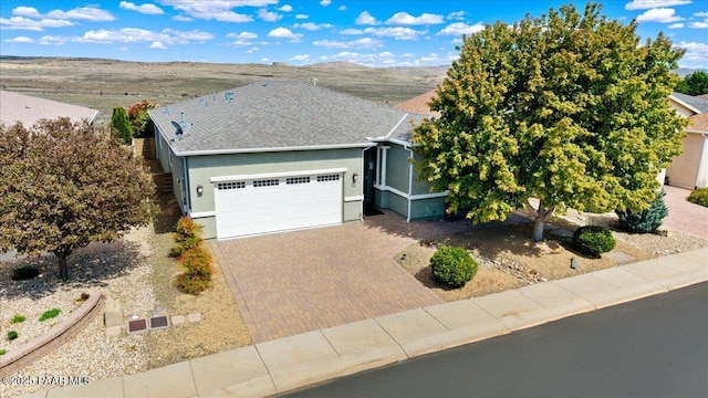 921 N Soliz St, Dewey-Humboldt, AZ 86327 - ranch-style house featuring a garage, decorative driveway, stucco siding, and roof with shingles