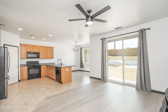 kitchen with ceiling fan, sink, hanging light fixtures, kitchen peninsula, and black appliances