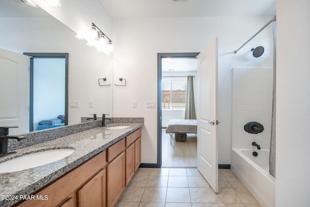 bathroom with tile patterned flooring, vanity, and  shower combination