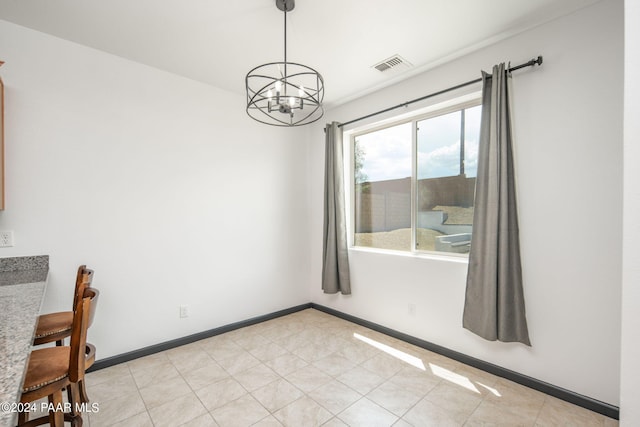 unfurnished dining area with a chandelier