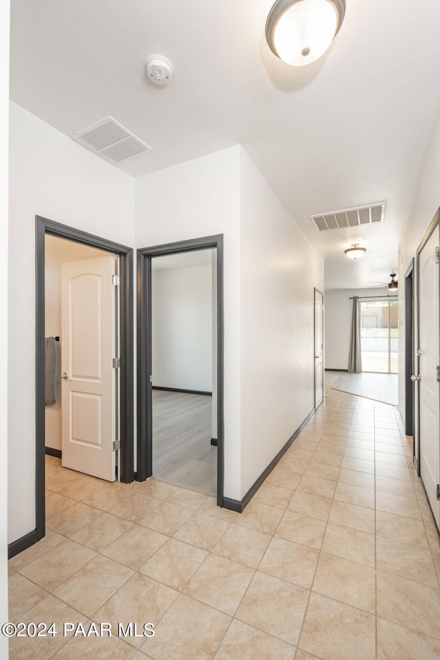 corridor featuring light tile patterned flooring