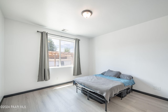 bedroom with light hardwood / wood-style floors