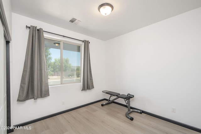 exercise room featuring light hardwood / wood-style floors