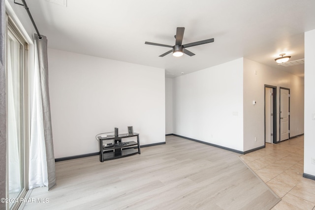 spare room featuring light hardwood / wood-style flooring and ceiling fan