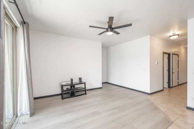 spare room featuring light hardwood / wood-style flooring and ceiling fan