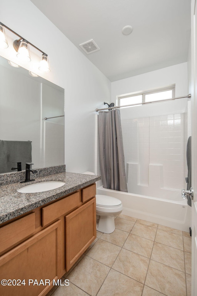 full bathroom with tile patterned floors, shower / bath combination with curtain, toilet, and vanity