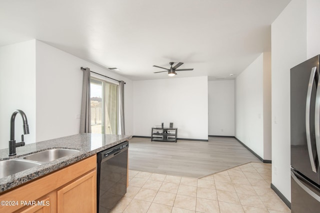 kitchen featuring stainless steel fridge, ceiling fan, sink, black dishwasher, and light hardwood / wood-style floors