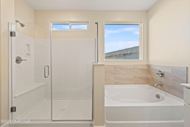 bathroom featuring separate shower and tub