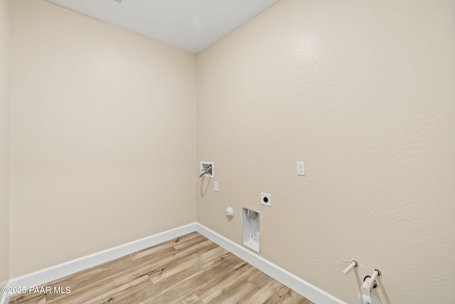 laundry room with hardwood / wood-style floors, gas dryer hookup, hookup for an electric dryer, and washer hookup