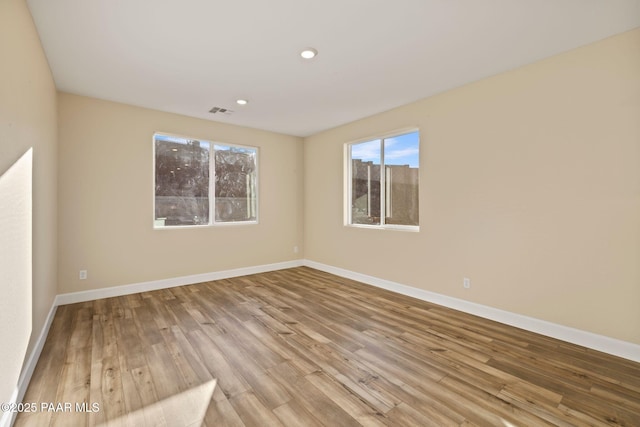 spare room with light hardwood / wood-style floors