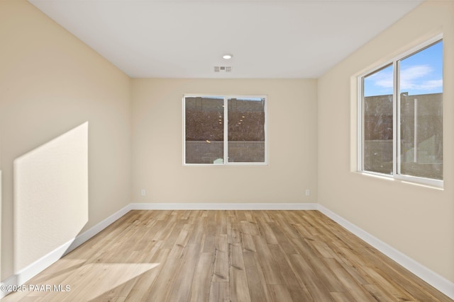 empty room with light hardwood / wood-style flooring