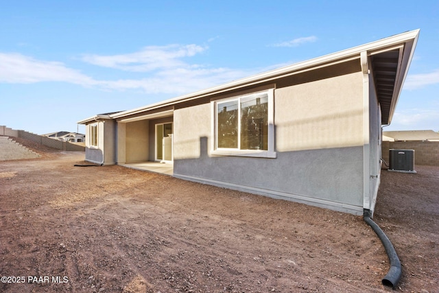 rear view of property with cooling unit