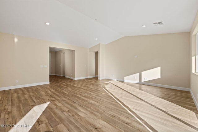 unfurnished living room with vaulted ceiling and light hardwood / wood-style flooring