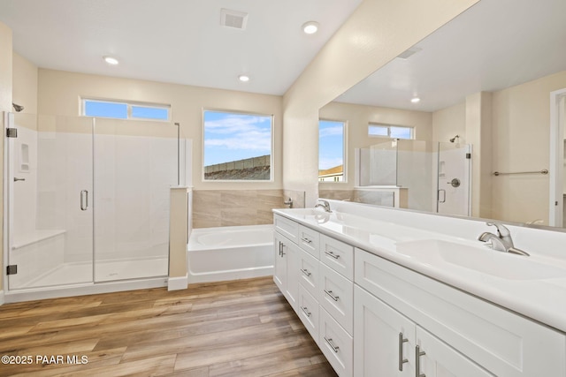 bathroom featuring vanity, hardwood / wood-style floors, and independent shower and bath