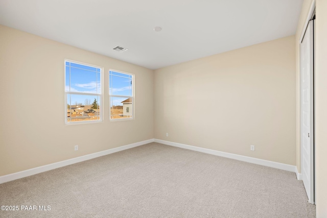 unfurnished bedroom with light carpet and a closet