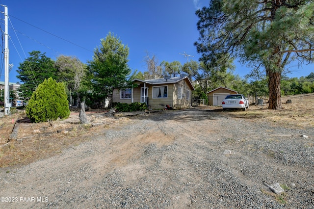 view of front of home featuring a garage and an outdoor structure