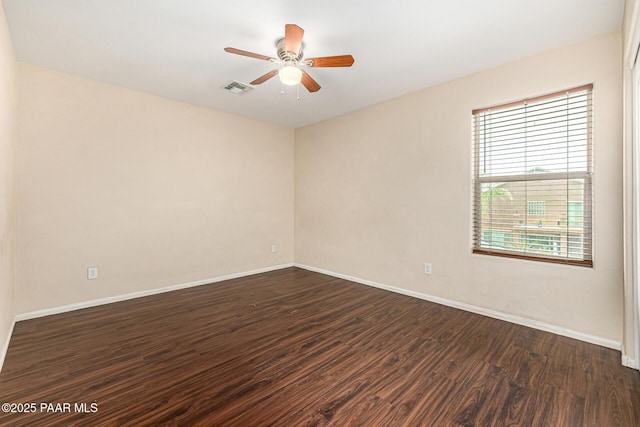 8214 S 48th Dr, Laveen, AZ 85339 - unfurnished room featuring dark wood-type flooring and a ceiling fan