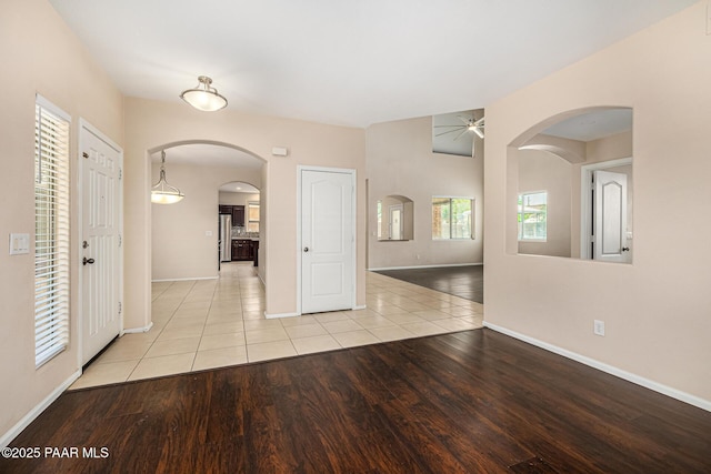 8214 S 48th Dr, Laveen, AZ 85339 - unfurnished room with a ceiling fan, arched walkways, and wood finished floors