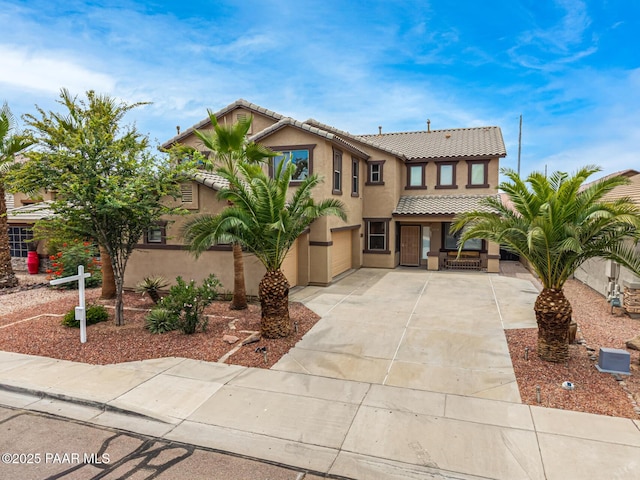 8214 S 48th Dr, Laveen, AZ 85339 - view of front of house featuring a tiled roof, concrete driveway, a porch, and stucco siding