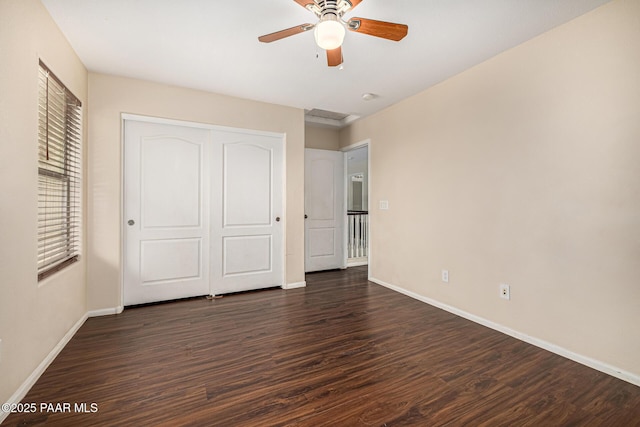 8214 S 48th Dr, Laveen, AZ 85339 - unfurnished bedroom featuring dark wood-style flooring, a closet, and a ceiling fan