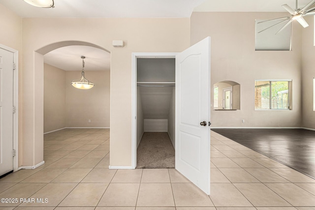 8214 S 48th Dr, Laveen, AZ 85339 - unfurnished bedroom featuring arched walkways, light tile patterned flooring, and a closet