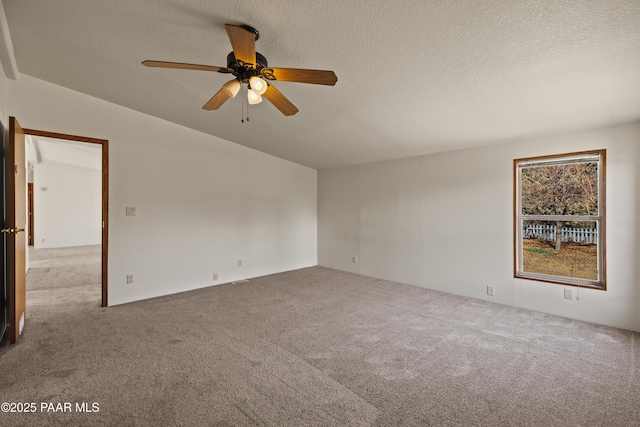 spare room with ceiling fan, carpet, and a textured ceiling