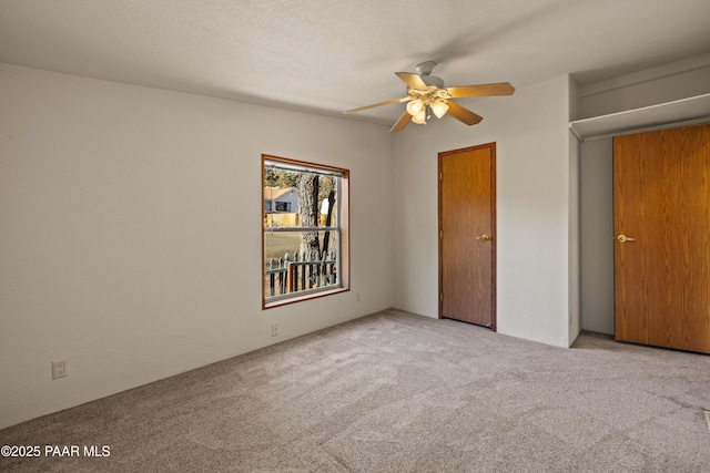 unfurnished bedroom with light carpet and a textured ceiling