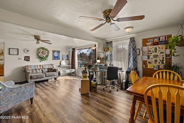 interior space featuring ceiling fan, hardwood / wood-style floors, and a textured ceiling