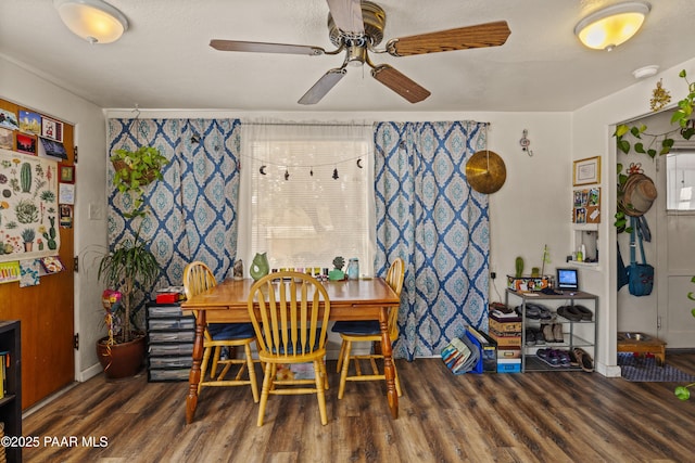 dining space featuring ceiling fan and dark hardwood / wood-style flooring