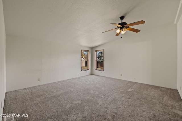 carpeted empty room featuring ceiling fan and a textured ceiling