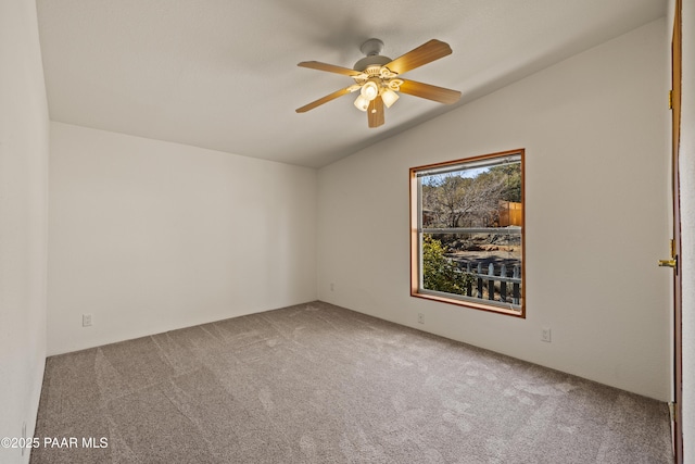 carpeted empty room featuring lofted ceiling and ceiling fan