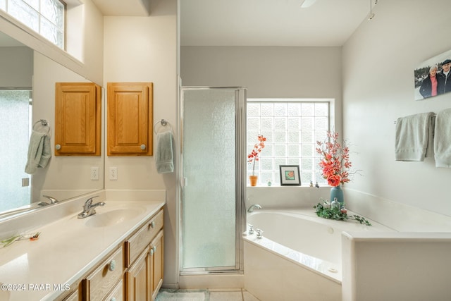 bathroom with tile patterned floors, vanity, and separate shower and tub